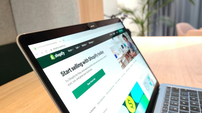 The Shopify sign-up page open on a laptop
